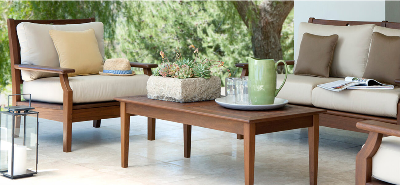 Outdoor patio furniture set with cushions and table.