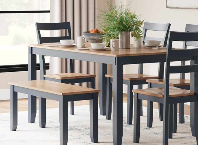 A dining room arrangement highlighting a table with four chairs and a bench, ideal for dining and social interaction.