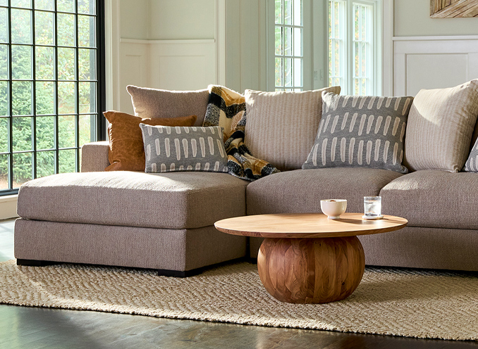 A cozy living room featuring a sectional couch and a stylish coffee table, creating a welcoming atmosphere.