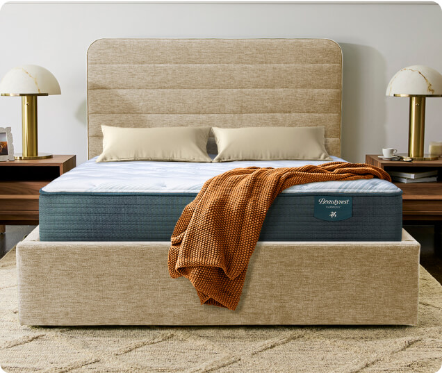 A beige-covered mattress displayed on a neutral background, showcasing its soft texture and elegant design.