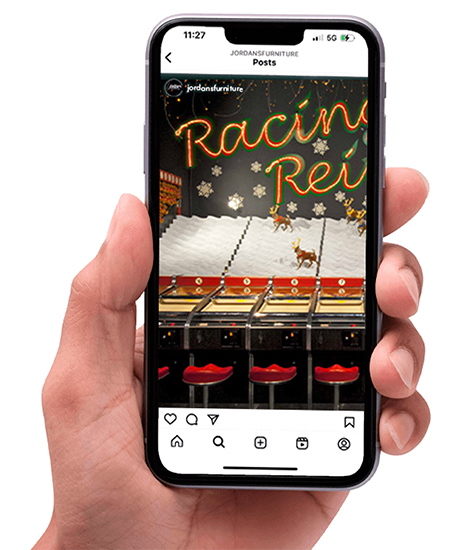 A close-up of the Racing Rev iPhone app interface showcasing vibrant graphics and racing elements on a smartphone screen.