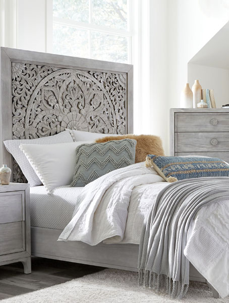 Bedroom with grey bed, dresser, and nightstand.