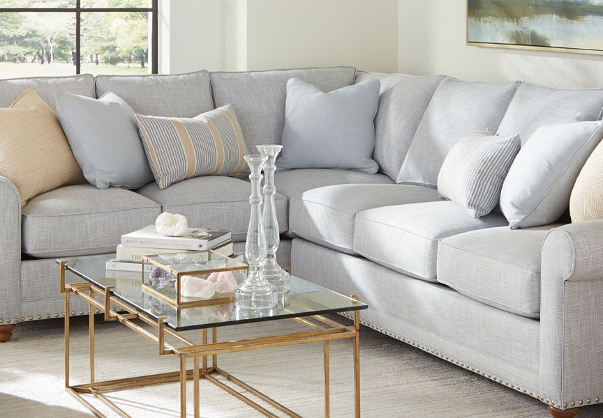 An inviting living room featuring a grey, plush couch and a sleek coffee table.