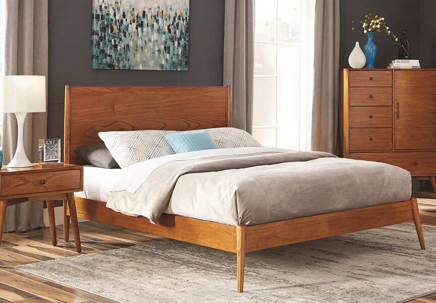 A cozy bedroom with a neatly made bed, a light wooden dresser and nightstand.