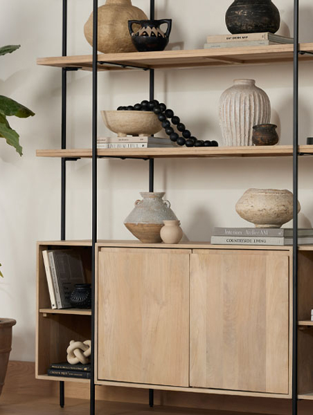 Wood shelving with sleek black metal legs containing clay vases of varying sizes.