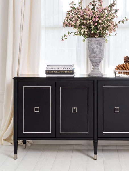 A sleek black sideboard with two drawers and a decorative vase.