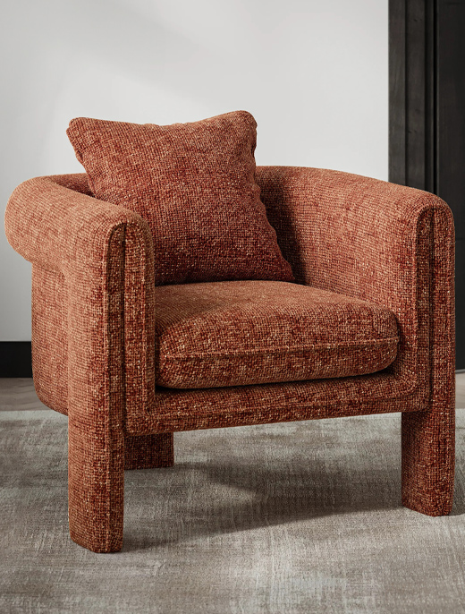 A contemporary rust-colored chair, featuring a minimalist design that adds warmth and elegance to modern living spaces.