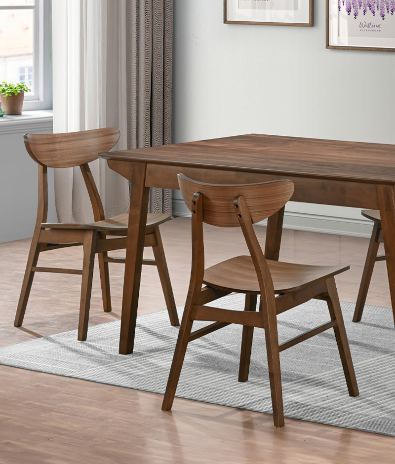 A wooden dining table surrounded by four chairs, elegantly set for a meal in a cozy dining area.