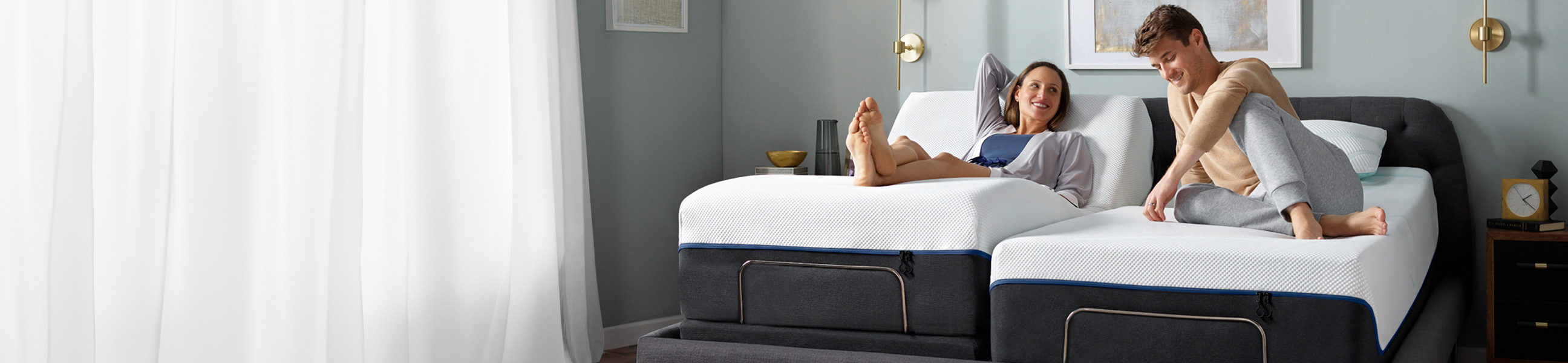 A couple relaxing together on a bed, enjoying each other's company on a comfortable mattress.