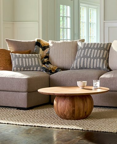 A cozy living room featuring a comfortable couch, a stylish coffee table, and a soft rug on the floor.