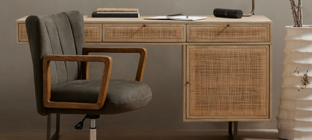 A desk featuring a chair and a stylish vase, exemplifying a clean and organized work environment.