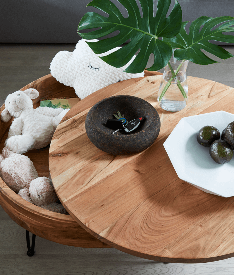 A wooden coffee table featuring a woven basket placed on its surface, showcasing a cozy and inviting living space.