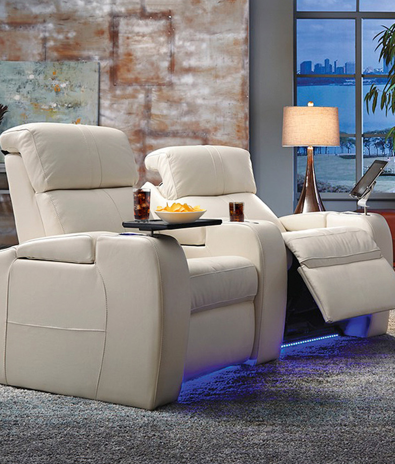 A reclining chair featuring a softly illuminated headrest, providing comfort and a soothing ambiance for relaxation.